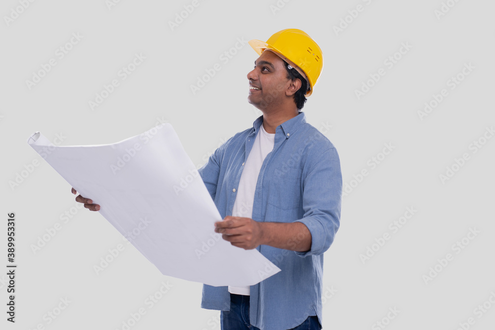 Construction Worker Holding House Plan in Hands Watching up. Architect Holding Blueprints. Yellow Hard Helmet. Construction Worker Holding House Plan in Hands Watching up. Architect Holding Blueprints. Yellow Hard Helmet.