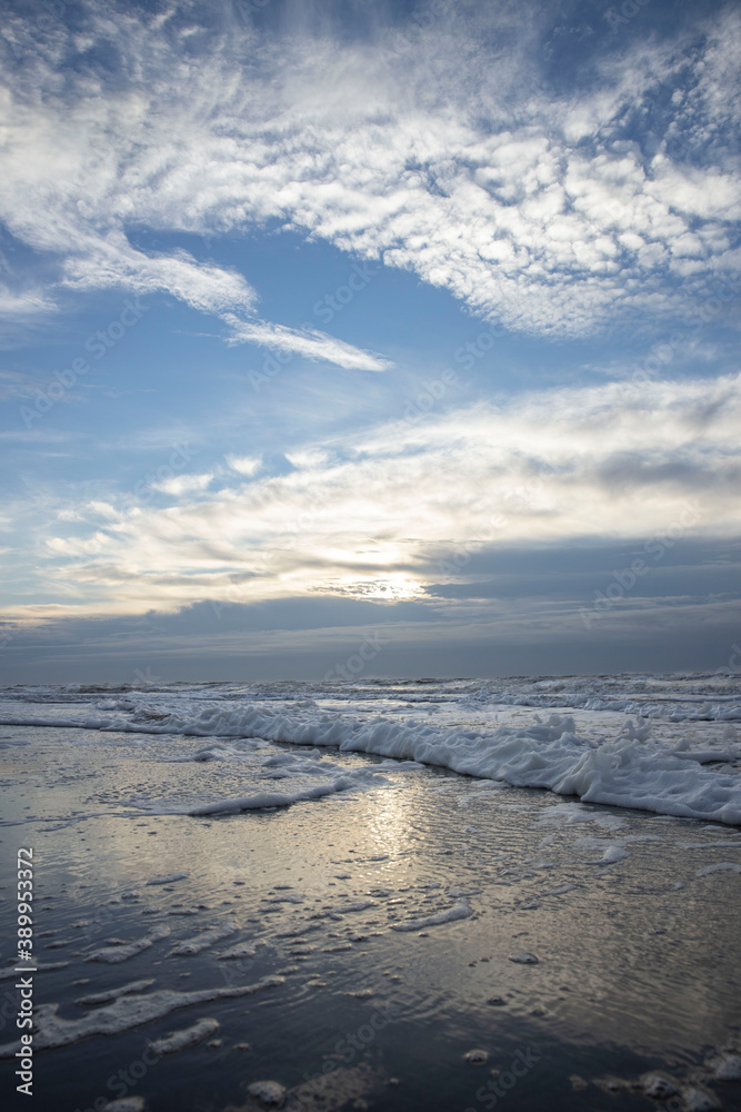 Sea, waves and beach. North sea coast. Julianadorp. Netherlands. Clouds. 