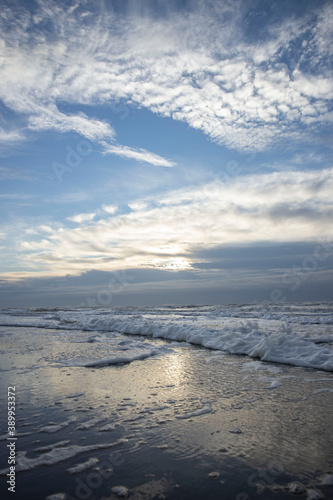 Sea  waves and beach. North sea coast. Julianadorp. Netherlands. Clouds. 