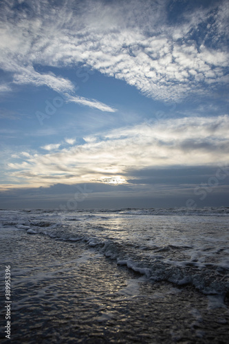 Sea  waves and beach. North sea coast. Julianadorp. Netherlands. Clouds. 