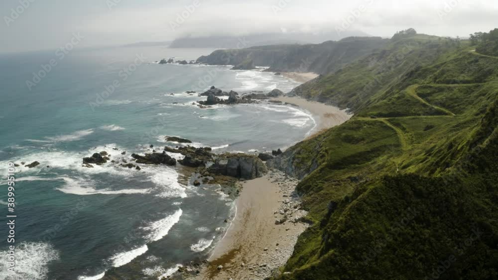 aerial drone shot flying in circle in a amazing coastline with cliffs waves and mountains aerial drone shot flying in circle in a amazing coastline with cliffs waves and mountains