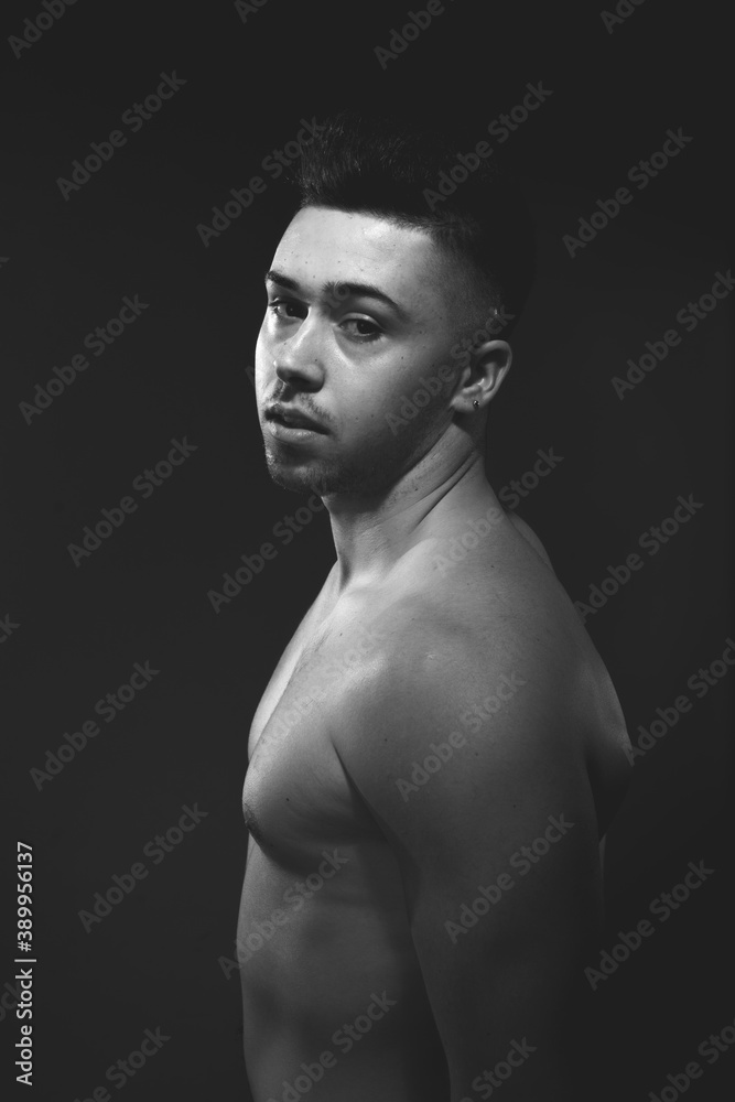 Fototapeta premium Handsome man posing at the studio without clothes at the torso