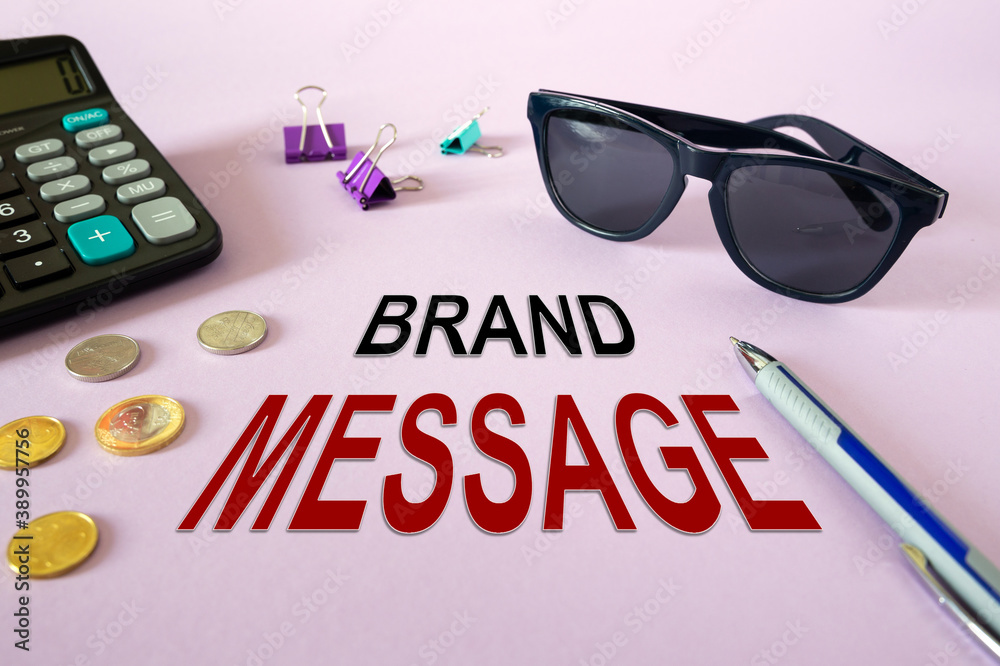 Text writing BRAND MESSAGE. Calculator, money and glasses Text writing BRAND MESSAGE. Calculator, money and glasses