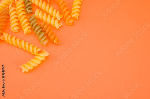 shot of whole durum wheat fusilli raw Italian pasta flavored with tomato and basil