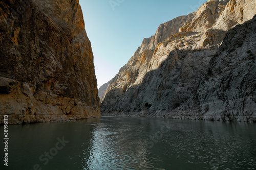 Boat tour on the river in the canyon. Cliffs of the canyon from the level of river ground. canyon at sunset.