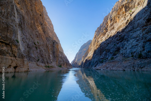 Boat tour on the river in the canyon. Cliffs of the canyon from the level of river ground. canyon at sunset.