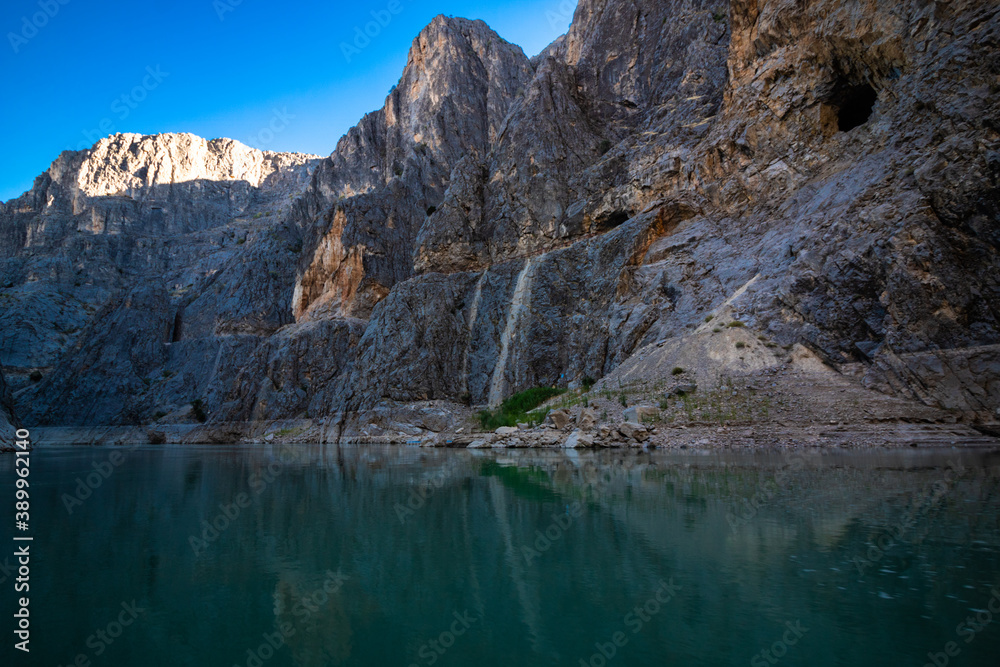 Boat tour on the river in the canyon. Cliffs of the canyon from the level of river ground. canyon at sunset. Boat tour on the river in the canyon. Cliffs of the canyon from the level of river ground. canyon at sunset.