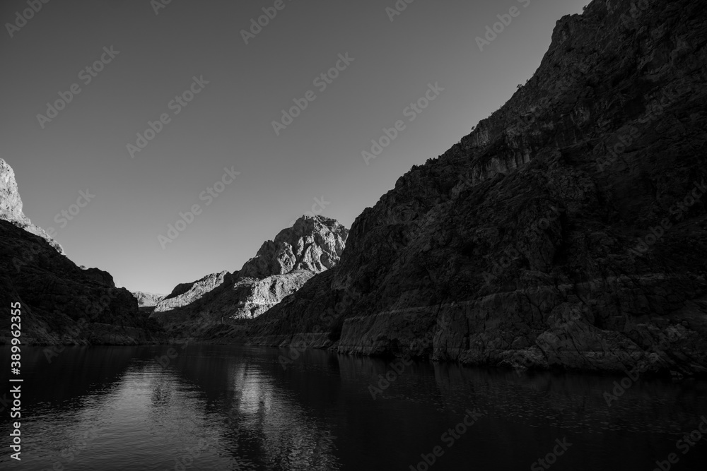 Cliffs of the canyon in black and white shot. Canyon and the river. High cliffs and river.
