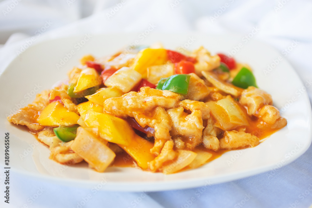 A view of a plate of sweet and sour chicken. A view of a plate of sweet and sour chicken.