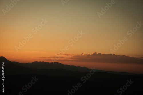 Silhouette of hills at sunset © senerdagasan