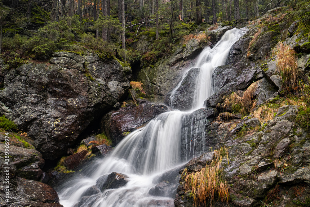 waterfall cascades in the rock in autumn forest, bohemian forest, germany waterfall cascades in the rock in autumn forest, bohemian forest, germany