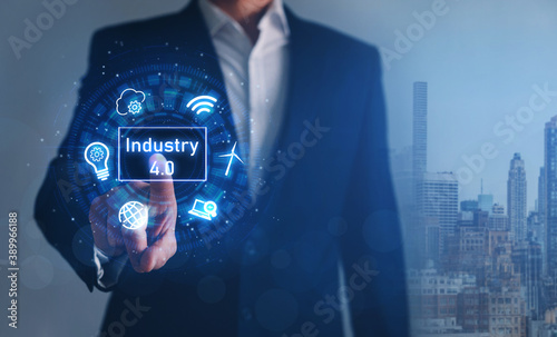  Industry 4.0. Businessman touching hologram with icons. Industrial technology concept. 