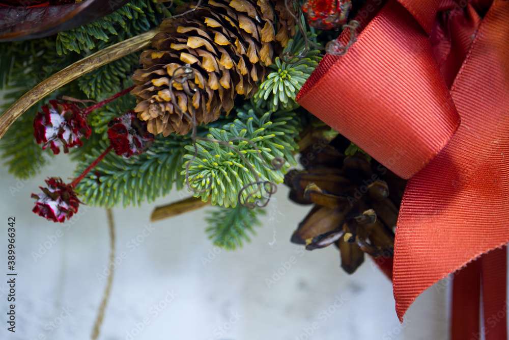 Close-up Christmas horseshoe wreath decorated with fir branches, Christmas balls and natural materials, New Year concept