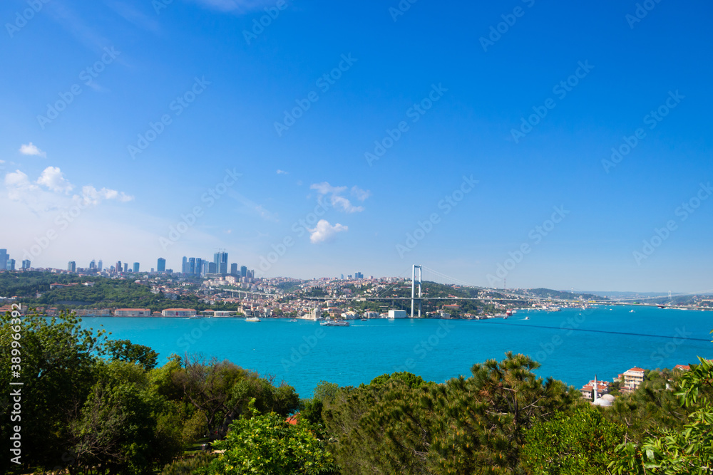 Cityscape of Istanbul. Bosphorus bridge and turquoise colored Istanbul Strait from Fethi Pasa Forest.