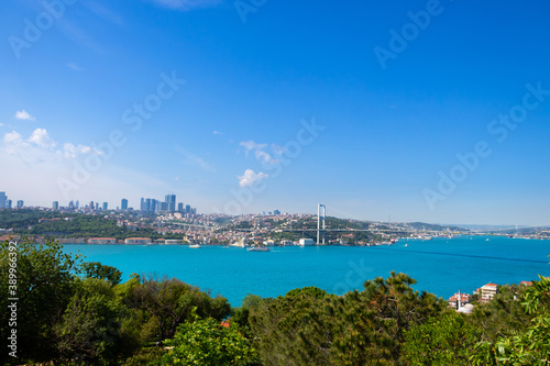 Cityscape of Istanbul. Bosphorus bridge and turquoise colored Istanbul Strait from Fethi Pasa Forest.
