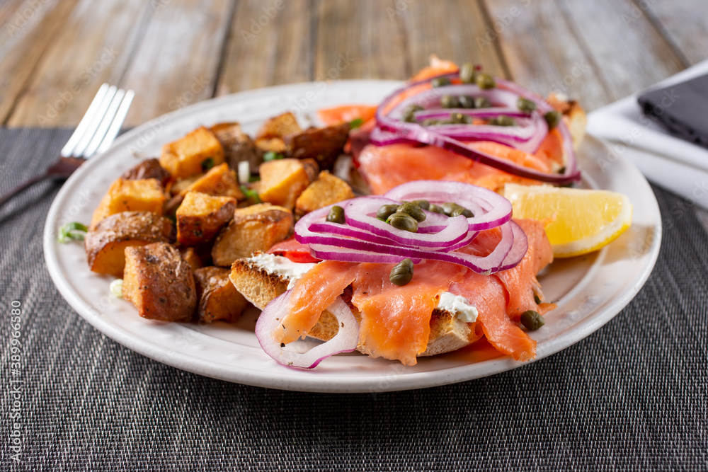 A view of a plate of lox on ciabatta bread.