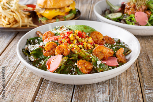 A view of several New American style entrees, featuring a Southwestern Tex-Mex shrimp salad.