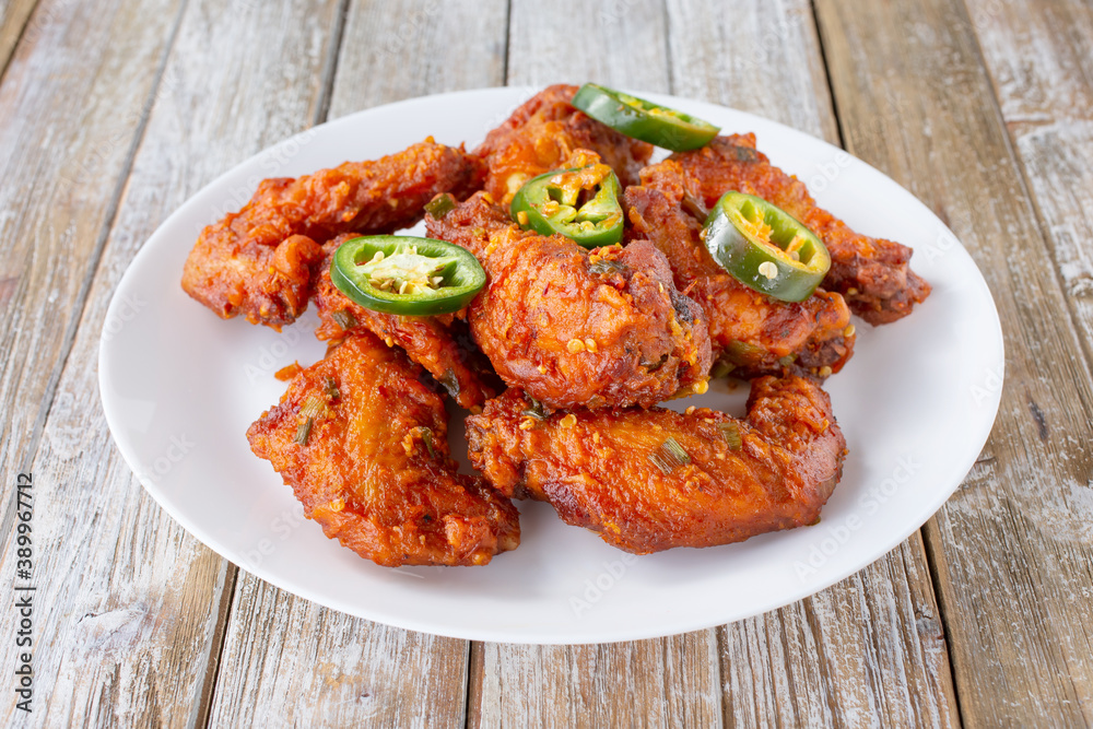 A view of a plate of spicy Chinese chicken wings.