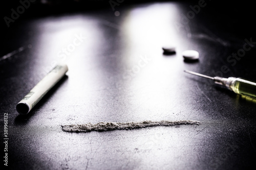 row or row of cocaine, illegal drugs in a dark setting, "dope", use of illegal substances