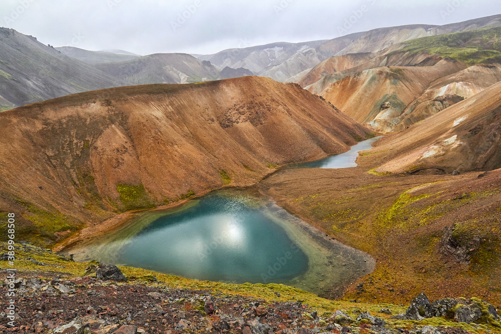 Icelandic rainbow mountains, a popular tourist destination, without tourists in autumn colors, volcanic activity, emerald pearl in the middle of a volcanic area, emerald lake