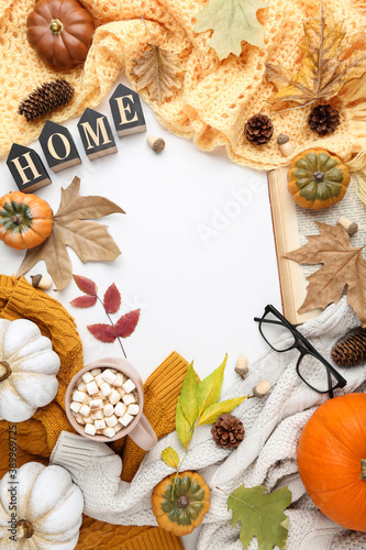 Cup of coffee with pumpkins, dry leafs, eyeglasses, knitted sweaters and word Home