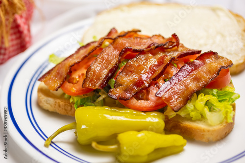 A view of a BLT sandwich, featuring bacon, lettuce and tomato.