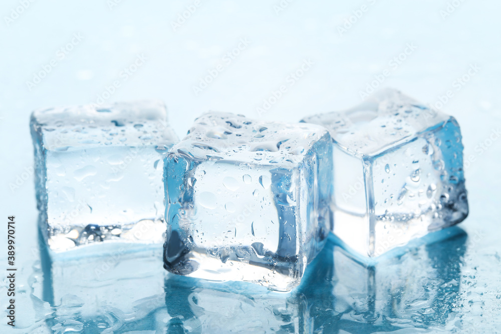 Ice cubes with water drops on blue background Ice cubes with water drops on blue background