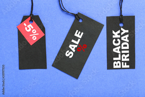 Sale tags with text Sale, Black Friday, five percents on blue background
