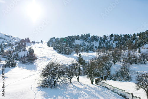 Ski and skateboard trails at Beldersay resort in the Tien Shan mountains in Uzbekistan in winter on a Sunny clear day. Beautiful winter landscape