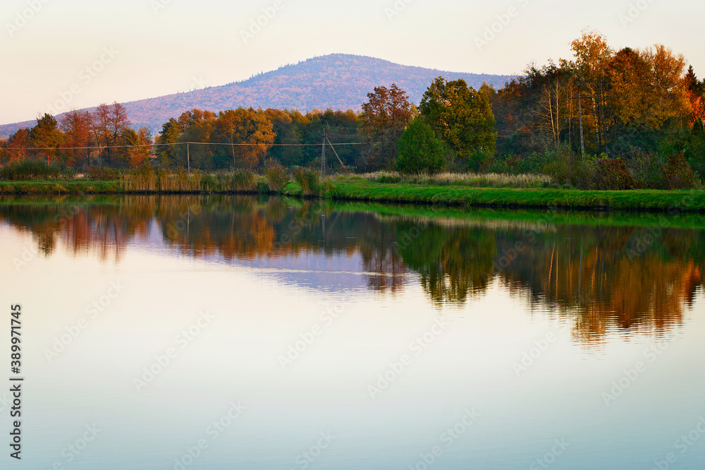 Ciekoty lake with view on Lysica mountain peak. Swietokrzyskie Mountains, Poland.