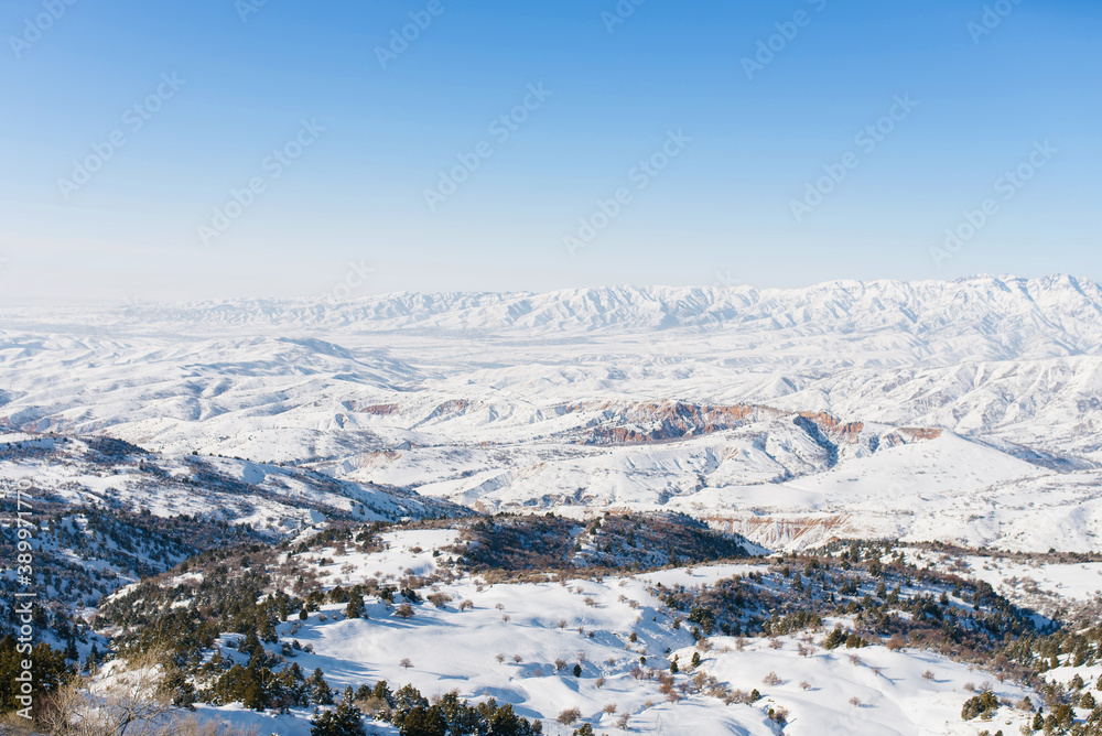 Beautiful winter panorama of the Tien Shan mountains in Uzbekistan in the Beldersay ski resort on a clear winter day