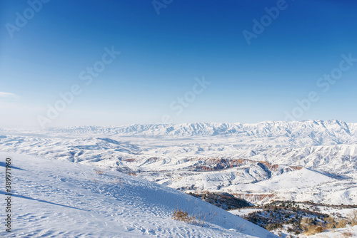 Picturesque Tien Shan mountains in Uzbekistan, partially covered with snow, winter clear Sunny day in the mountains photo