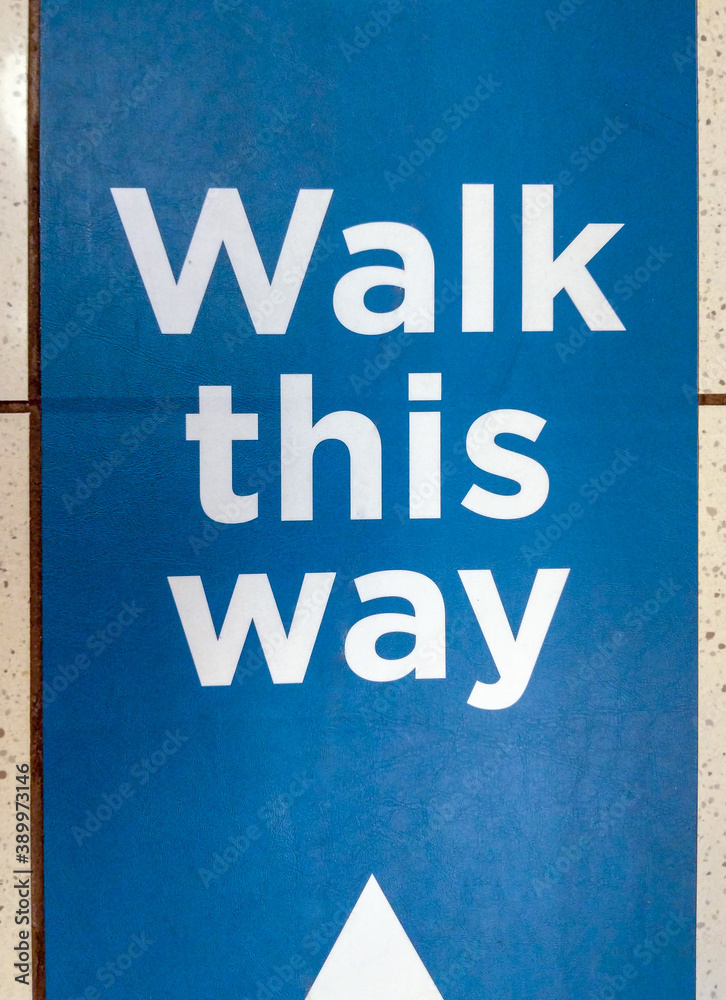 Close-up of Sign Indicating Restricted Hallway Or Aisle Travel on Blue Background