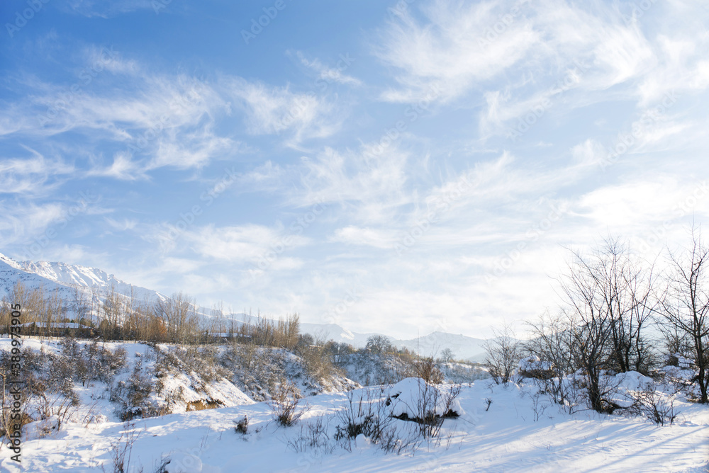 Snowy beautiful winter landscape of the Tien Shan mountains in Uzbekistan on a frosty Sunny day with blue sky and Cirrus clouds. Chimgan Snowy beautiful winter landscape of the Tien Shan mountains in Uzbekistan on a frosty Sunny day with blue sky and Cirrus clouds. Chimgan