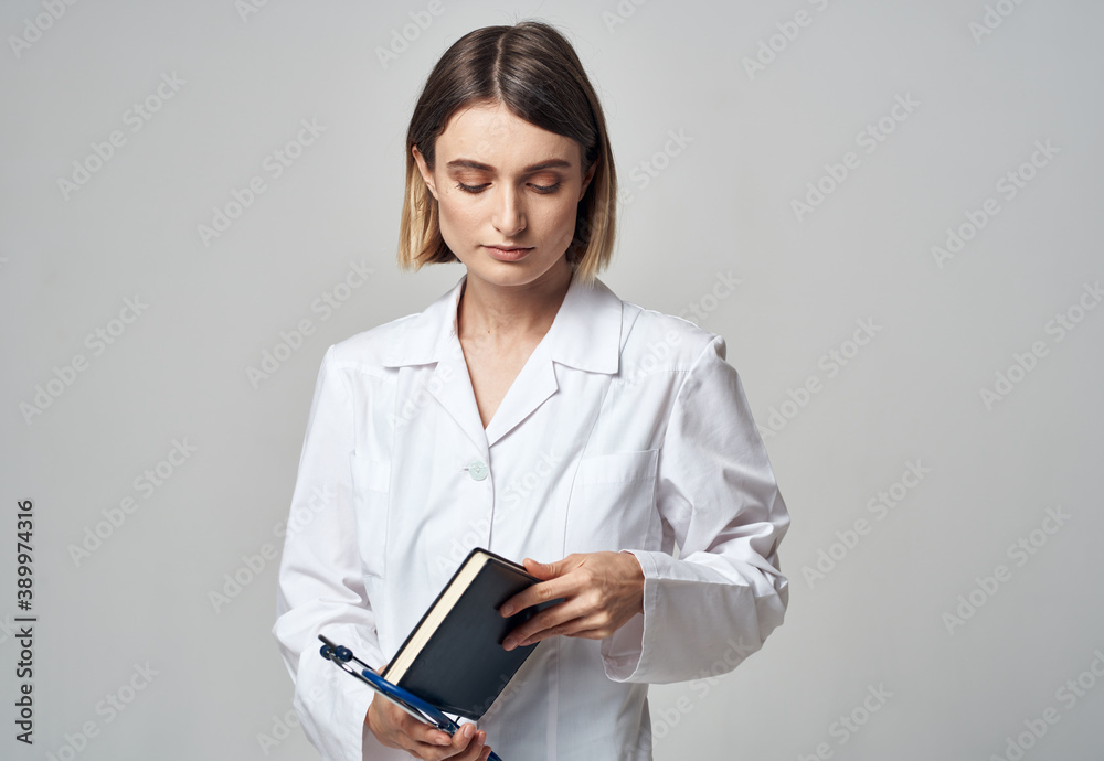 woman doctor with stethoscope and medical gown documents in hands woman doctor with stethoscope and medical gown documents in hands