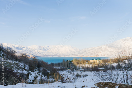 Charvak reservoir with blue water on a clear winter day in Uzbekistan