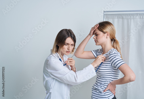 woman at the doctor s appointment medical gown stethoscope health