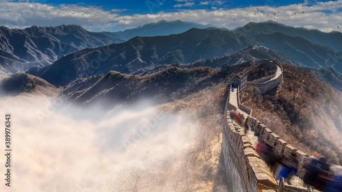 The great wall of china bathed in morning sunlight with moving clouds