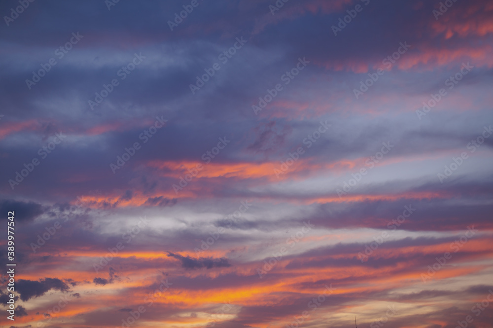 Beautiful colorful sunset sky of red, orange, yellow, black, blue and cyan colors. Nature background.