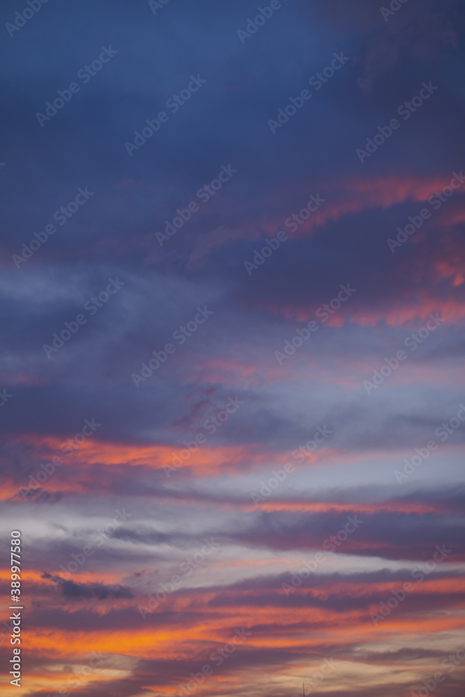 Beautiful colorful sunset sky of red, orange, yellow, black, blue and cyan colors. Nature background.
