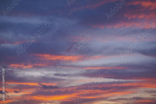 Beautiful colorful sunset sky of red, orange, yellow, black, blue and cyan colors. Nature background. © shutnica