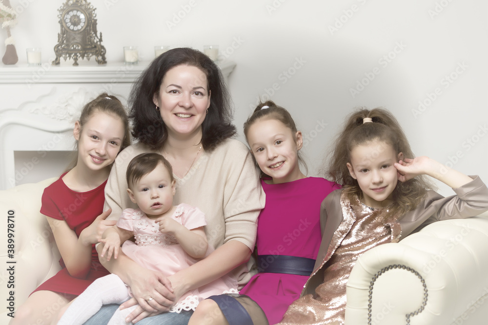 Studio Portrait of Happy Family of Mother and Three Daughters