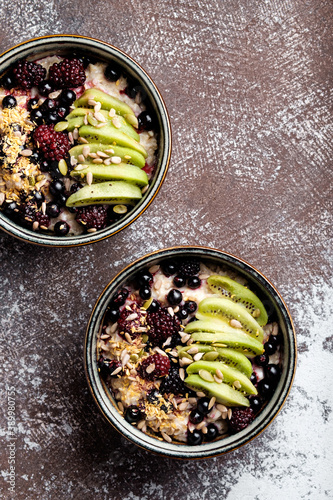 Delicious and healthy breakfast oatmeal with kiwi and berries