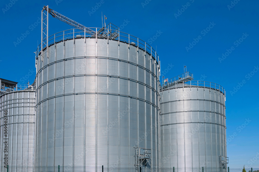 Granary. A large modern  agro-processing plant for the storage and processing of grain crops. Large metal barrels of grain. Granary elevator.