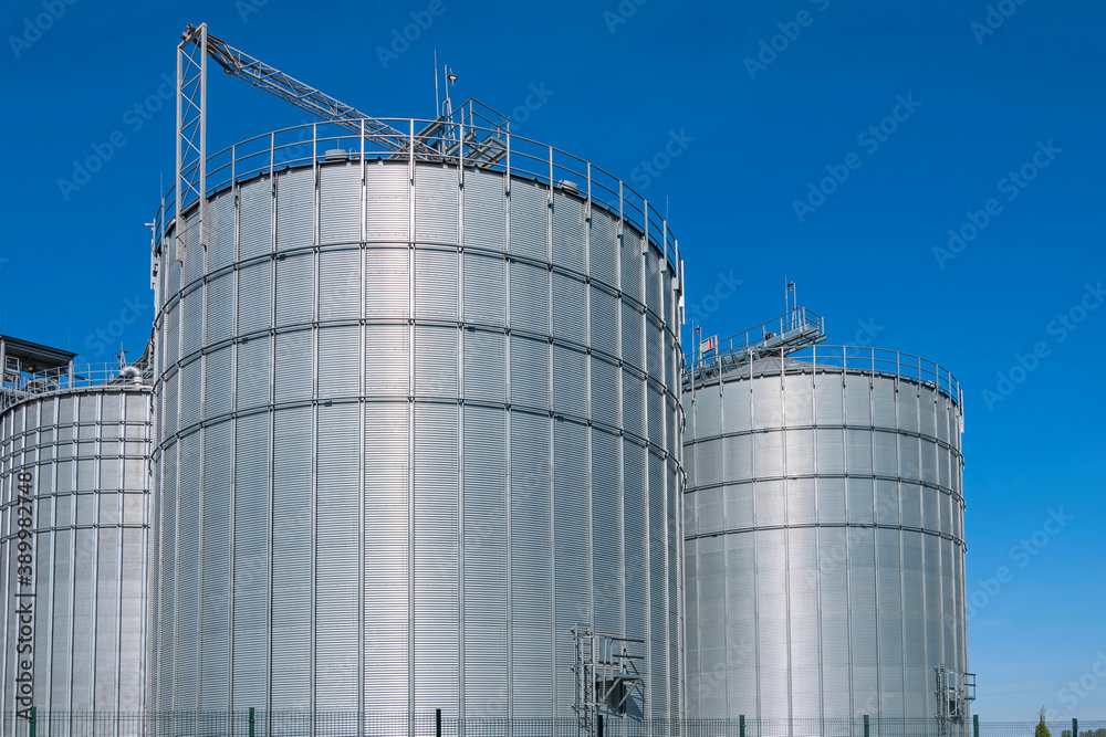 Granary. A large modern agro-processing plant for the storage and processing of grain crops. Large metal barrels of grain. Granary elevator. Granary. A large modern agro-processing plant for the storage and processing of grain crops. Large metal barrels of grain. Granary elevator.