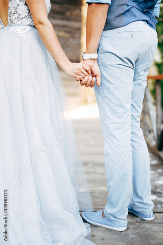 hands of groom and bride hold together
