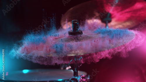 Freeze motion of coloured powder explosion on drum cymbal