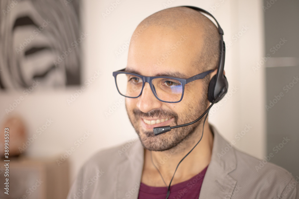 Call center operator is talking with headset. Customer service or Helpdesk concept. Cheerful operator helps his costumers. Caucasian man Call center operator is talking with headset. Customer service or Helpdesk concept. Cheerful operator helps his costumers. Caucasian man
