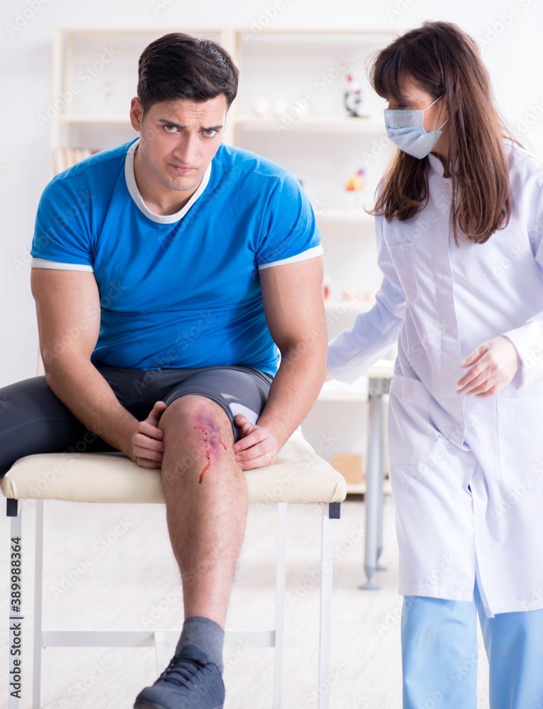 Fototapeta premium Patient visiting doctor after sustaining sports injury