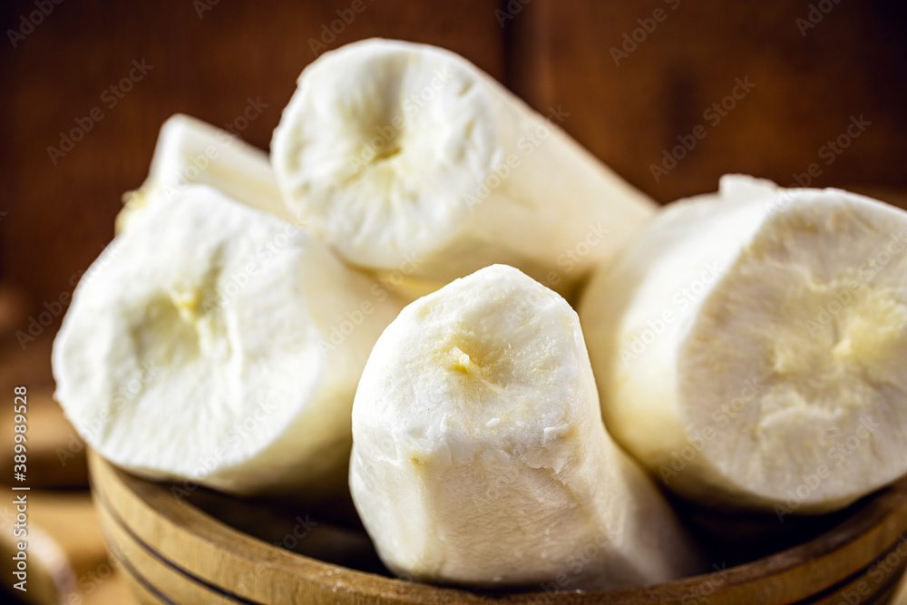 cassava, a root used in Brazilian cuisine, called macaxeira, cassava, castelinha, uaipi, sweet cassava, maniva, maniveira and poor bread. root inside wooden pots cassava, a root used in Brazilian cuisine, called macaxeira, cassava, castelinha, uaipi, sweet cassava, maniva, maniveira and poor bread. root inside wooden pots